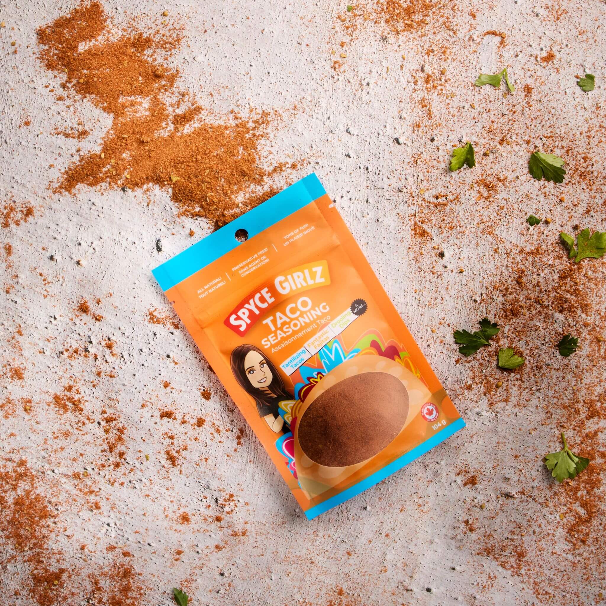 Spyce Girlz Taco Seasoning blend being poured from pouch